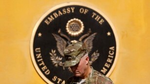 A U.S. officer observes a moment of silence during an event to mark the 10th anniversary of the 9/11 attack on the World Trade Center, at the U.S. embassy in Kabul September 11, 2011 REUTERS/Omar Sobhani (AFGHANISTAN - Tags: ANNIVERSARY MILITARY POLITICS 