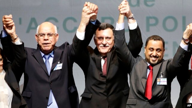 Libyan representatives from rival factions, left to right, Mohammed Chouaib, Fayez Sarraj, and Dr. Saleh Almkhozom react after signing a U.N.-sponsored deal aiming to end Libya's conflict, Dec.17, 2015 in Sikhrat, Morocco.