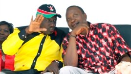 The National Alliance Party (TNA) presidential candidate Deputy Prime Minister Uhuru Kenyatta right, and his running mate William Ruto, talk during a rally at Uhuru Park, in Nairobi, January 12, 2013.