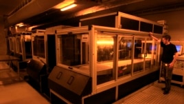 A technician at Belgian company Materialise operates a Materialise-patented Mammoth stereolithography machine, capable of printing parts of up to 2100x680x800mm in one piece, to create 3D objects, at the company's headquarters in Leuven, Jan. 24, 2013.