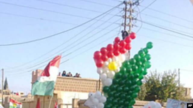 Demonstrators protesting against Syria's President Bashar al-Assad march through the streets on the first day of the Muslim festival of Eid-al-Adha in Alsnmin near Daraa, November 6, 2011.