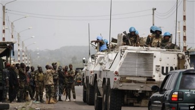 United Nations soldiers talk to forces loyal to Alassane Ouattara as they drive through a republican forces operating base on the outskirts of Abidjan, Ivory Coast, April 9, 2011