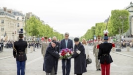 U.S. Secretary of State John Kerry (C) lays a wreath during a ceremony marking France's 70th anniversary of the allied victory over Nazi Germany, at the Tomb of the Unknown Soldier in Paris, France, May 8, 2015.