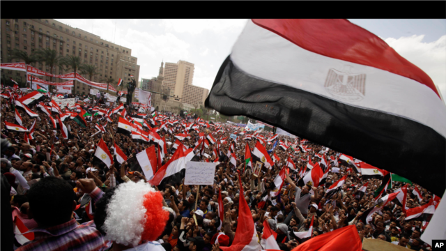 Protesters wave the Egyptian flag in Tahrir Square in Cairo, Egypt, Friday, April 8, 2011.