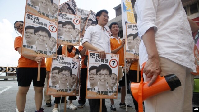 Pro-democracy candidates Ho Sau-Lan, right, and Cheng Sze-lut, third right, of the Labour Party attend a campaign for Legislative Council election in Hong Kong, September 9, 2012.
