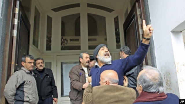 An anti-government protester chants slogans in front of the foreign media in Homs, Syria, January 23, 2012.