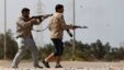 FILE - Fighters from Misrata fire weapons at Islamic State militants near Sirte, March 15, 2015. Militants loyal to Islamic State, the group that has seized much of Iraq and Syria, have established a larger presence in Libya.