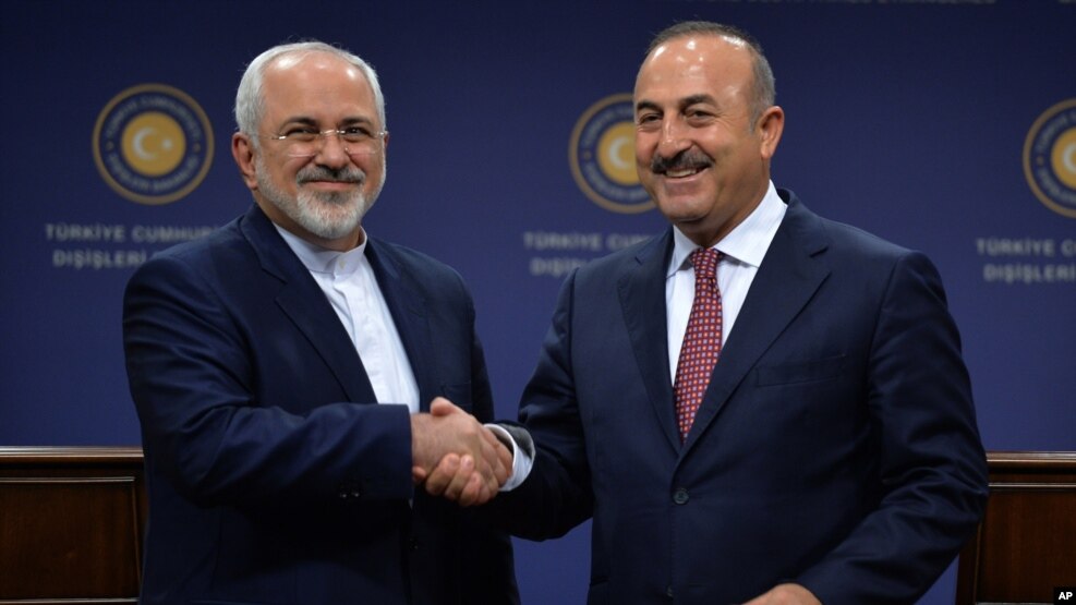 FILE - Foreign ministers Mohammad Javad Zarif of Iran, left, and Mevlut Cavusoglu meet in Ankara, Turkey, Aug. 12, 2016. Cavusoglu said he made a surprise visit to Tehran to enhance cooperation on Syria.