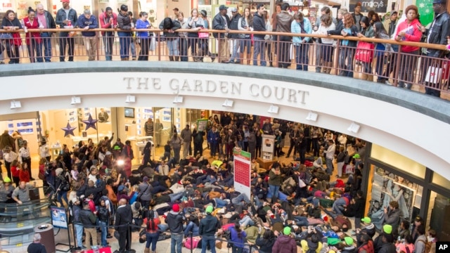 Protesters of the grand jury decision in the Michael Brown shooting march through the St. Louis Galleria mall chanting slogans, in Richmond Heights, Missouri, Nov. 28, 2014.