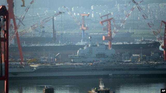 The 300-meter former Soviet carrier, originally called the Varyag, as she is overhauled in the northeast port of Dalian, northwest China's Liaoning province on July 4, 2011.