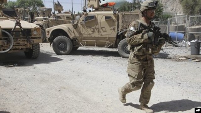 A US soldier, part of the NATO forces, patrols a police station after it was attacked by militants, Kandahar, Afghanistan, June 19, 2012.
