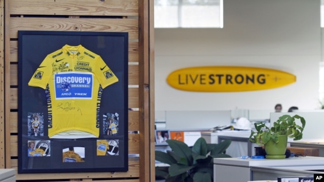 An autographed cycling jersey hangs in the offices of Livestrong, Lance Armstrong's cancer-fighting charity, October 17, 2012, in Austin, Texas. 