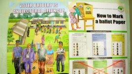 Kenyan elections posters discussed during an IEBC politician education forum in Mombasa, Kenya, Feb. 18, 2013." (Jill Craig/VOA)