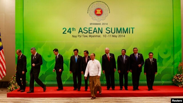 ASEAN leaders leave after taking a group picture at the 24th ASEAN Summit in Naypyidaw, Burma, May 11, 2014.