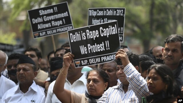 Indian protesters hold placards during a protest to demand for tougher rape laws and better police protection for women, outside the Parliament in New Delhi, India, April 22, 2013.