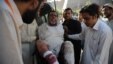 Pakistani paramedics shift an injured man into the hospital after a suicide blast in Mardan at the gathering of funeral prayers, in Peshawar, June 18, 2013.