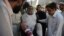 Pakistani paramedics shift an injured man into the hospital after a suicide blast in Mardan at the gathering of funeral prayers, in Peshawar, June 18, 2013.