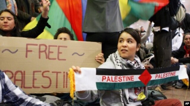 Demonstrators sit as around 100 pro-Palestinian activists stage a protest at Brussels national airport in Zaventem, Israel, early April 15, 2012. 