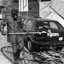 A 1986 file photo shows firefighters in protective gear washing a West German car near Herleshausen at the East German border after it arrived from Poland bearing radioactive fallout from the Chernobyl nuclear plant disaster