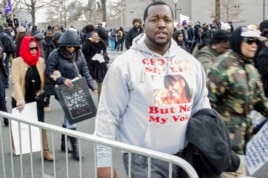 Martinez Sutton, whose sister Rekia Boyd was killed by an off-duty police officer in Chicago in 2012, adds his voice to the thousands who attended the "Justice for All" march in Washington, D.C., Dec. 13, 2014. (Elizabeth Pfotzer/VOA)