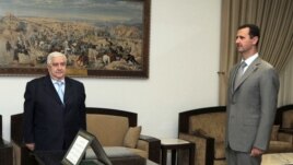 Tổng thống Syria Bashar al-Assad và Ngoại trưởng Syria Walid Moallem tại Damascus. Ngoại trưởng Syria Walid Muallem cảnh báo các thương thuyết gia rằng bất cứ đề cập nào đến số phận của Tổng thống Syria đều không được phép đưa ra đàm phán.  