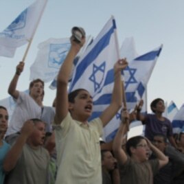 Settler youth from the settlement of Itamar in the West Bank march down a highway to demonstrate their ownership of the land, September 21, 2011