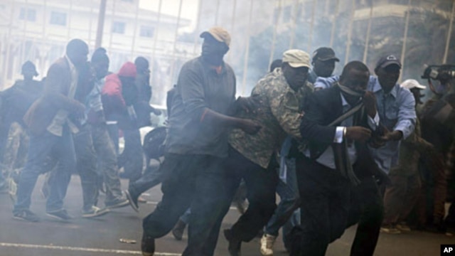 Anti-government protestors run from tear gas in Senegal's capital Dakar, February 15, 2012