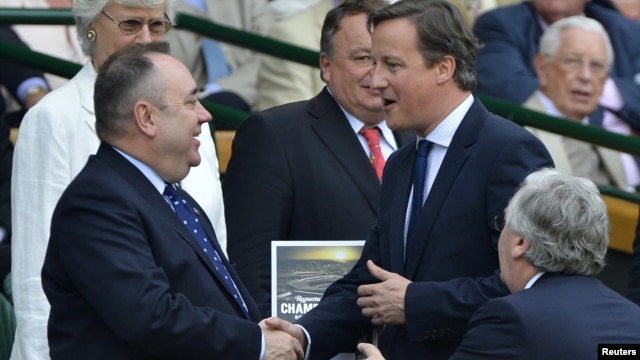 Britain's Prime Minister David Cameron (R) shakes hands with the First Minister of Scotland, Alex Salmond (L), July 8, 2012.