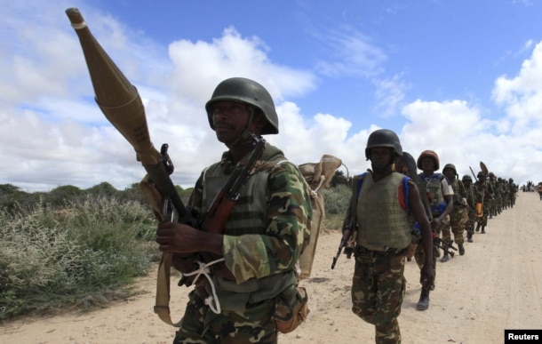 FILE - African Union Mission in Somalia (AMISOM) peacekeepers from Burundi patrol after fighting between insurgents and government soldiers erupted on the outskirts of Mogadishu.