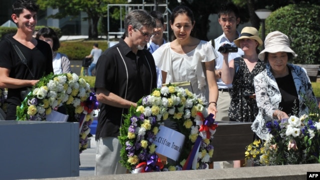 Clifton Truman Daniel (C) offers a wreath of flowers at the memorial cenotaph for the people killed by the atomic bomb at the Peace Memorial Park in Hiroshima, Japan, August 4, 2012.