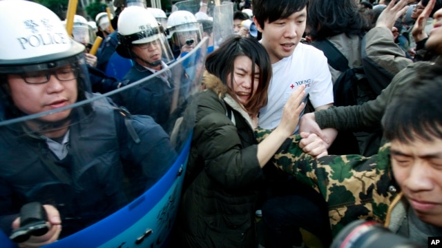 Sinh viên biểu tình chống hiệp ước mậu dịch với Trung Quốc bị cảnh sát đuổi khỏi tòa nhà nội các tại Đài Bắc, ngày 24/3/2014.