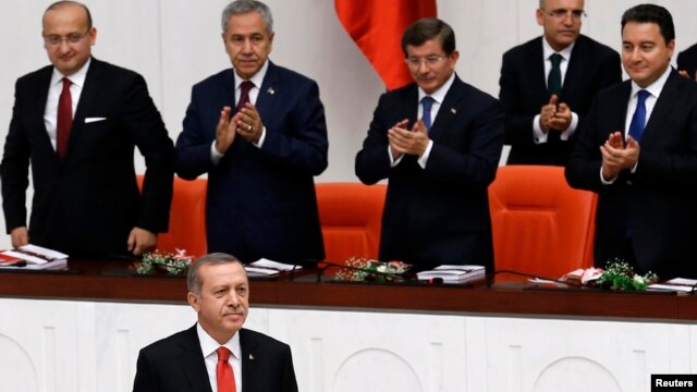 Turkey's President Recep Tayyip Erdogan, lower left, attends a debate marking the reconvening of parliament after a summer recess at the Turkish Parliament in Ankara, Oct. 1, 2014.  