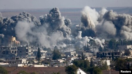 Smoke rises over Syrian town of Kobani after an airstrike, as seen from the Mursitpinar border crossing on the Turkish-Syrian border in the southeastern town of Suruc, Sanliurfa province, Oct. 18, 2014.