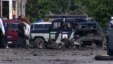 This image taken from AP video shows the scene of a blast with wreckage of a police car and debris littered over the ground in Makhachkala in the southern Russian region of Dagestan, May 25, 2013.