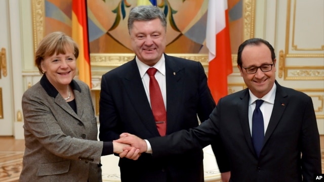 Ukrainian President Petro Poroshenko, center, German Chancellor Angela Merkel, left, and French President Francois Hollande show solidarity during their meeting in Kyiv, Ukraine, Feb. 5, 2015.