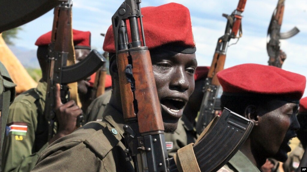 FILE - Government soldiers follow orders to raise their guns during a military parade in Juba, South Sudan, April 14, 2016.