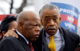 U.S. Rep. John Lewis (L) and the Rev. Al Sharpton confer during a voter's rights rally in front of the U.S. Supreme Court in Washington, Feb. 27, 2013.