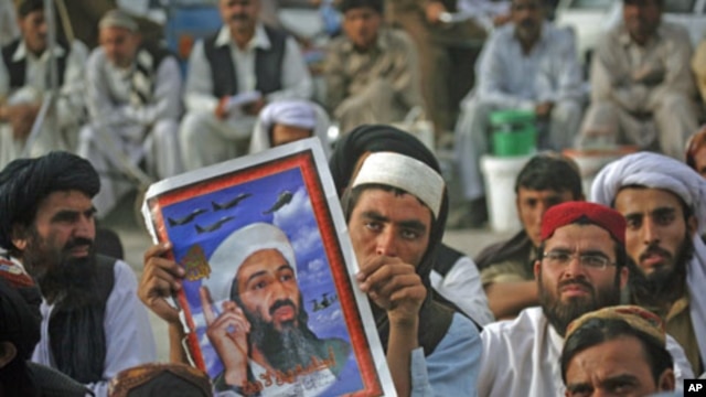 Supporters of Pakistani religious party Jamiat-e-Ulema-e-Islam hold an image of al-Qaida leader Osama bin Laden during an anti-American rally in Quetta, Pakistan, May 2, 2012.