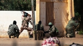 Malian soldiers fire at Islamists' positions at the mayor's office, in Gao, Mali, February 21, 2013.