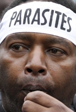 A July 8, 2010 photo shows a demonstrator blowing his whistle outside Parliament buildings in Kenya's capital Nairobi to protest the huge pay rises legislators have awarded themselves.
