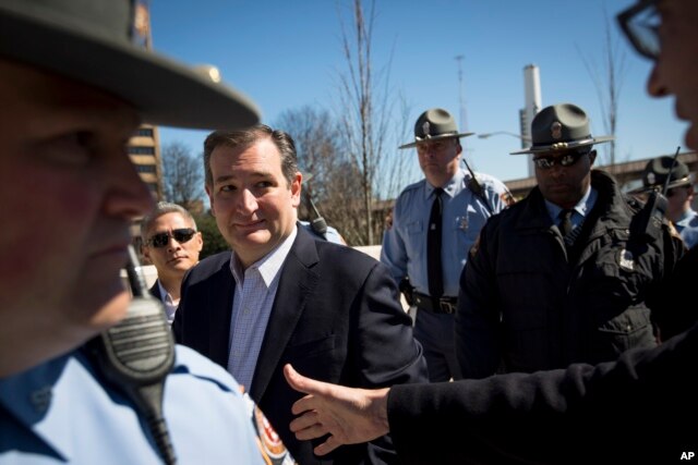 Republican presidential candidate Ted Cruz eyes a supporter reaching to shake his hand during a rally at Liberty Plaza in Atlanta, Feb. 27, 2016.