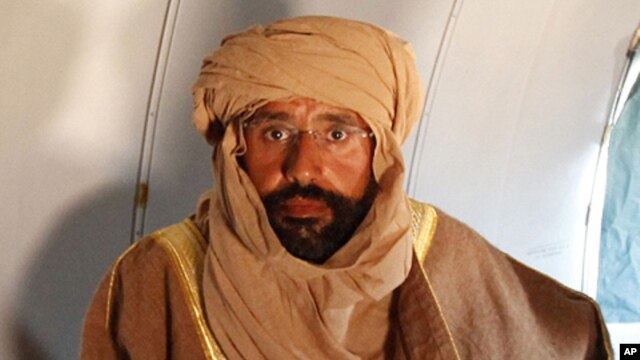 Seif al-Islam Gaddafi is seen sitting in a plane in Zintan November 19, 2011. He told Reuters on Saturday that he was feeling fine after being captured by fighters who overthrew his late father.