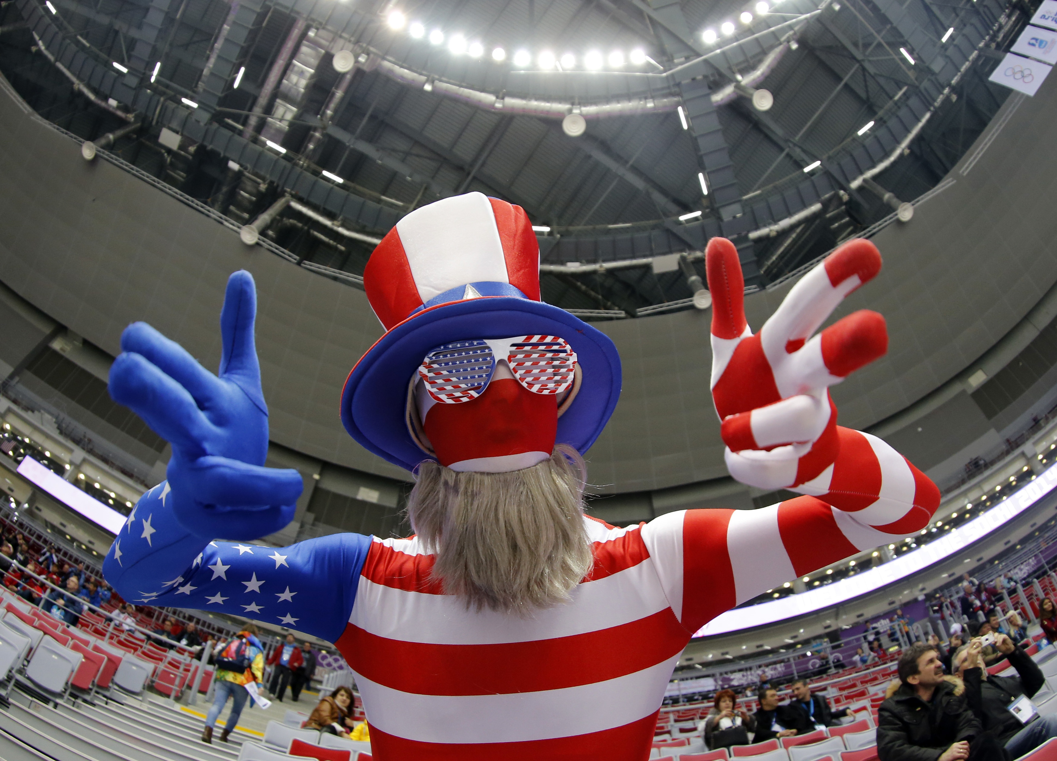 A fan of the U.S. dressed in a costume in the colours of their national flag gestures ahead of their women's ice hockey gold medal game against Canada at the Sochi 2014 Winter Olympic Games February 20, 2014.     