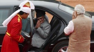 Nepal's Prime Minister Khadga Prasad Sharma Oli, center, greets his Indian counterpart, Narendra Modi, right, after his ceremonial reception at the forecourt of India's Rashtrapati Bhavan presidential palace in New Delhi, India, Feb. 20, 2016.  