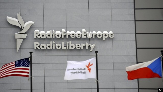 The headquarters of Radio Free Europe/Radio Liberty (RFE/RL) is seen with the United States, RFE/RL and the Czech Republic flags in the foreground, in Prague, January 15, 2010.