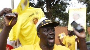 A supporter of Uganda's President Yoweri Museveni celebrate as the electoral commission declared Yoweri Museveni the winner of the presidential election in capital Kampala, Feb. 20, 2016. 
