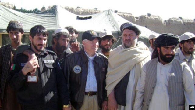Secretary Gates poses for a photo with village elders in Tabin, March 8, 2011