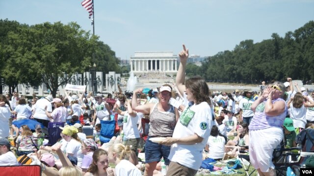 Tens of thousands of young people on the National Mall celebrate the 100th anniversary of Girl Scouts of the United States