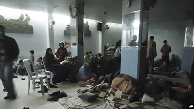 Residents rest in a shelter in is Baba Amr near Homs, February 8, 2012. Syrian forces thrusting into the rebellious city of Homs, killing dozens of civilians.