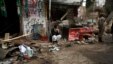A shopkeeper sits outside his shop, after it was damaged by a bomb attack in Quetta, Pakistan, April 24, 2013.